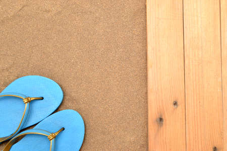 slippers on wood and sandの写真素材