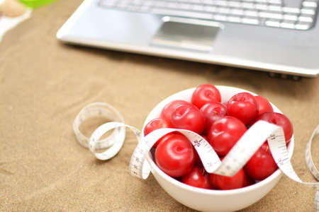 salad,laptop and tape measure on sandの写真素材