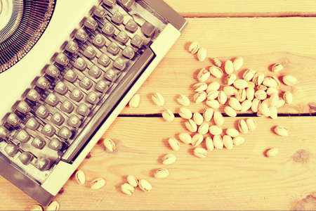 Typewriter and pistachiosの写真素材