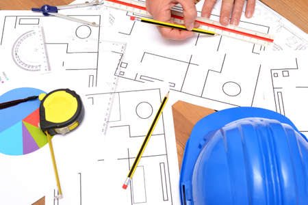 Architect working with blueprintsの写真素材
