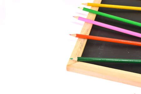 Notebook, colored pencils blackboardの写真素材