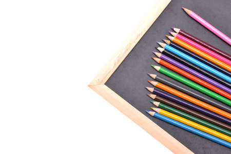 Notebook, colored pencils blackboardの写真素材