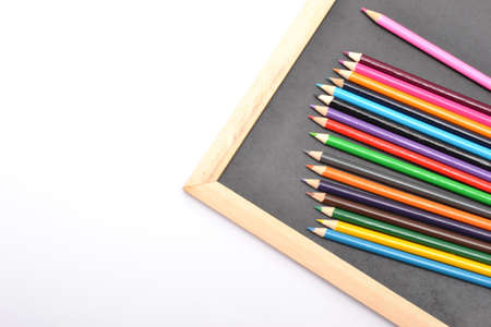 Notebook, colored pencils blackboardの写真素材