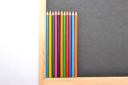 Notebook, colored pencils blackboardの写真素材