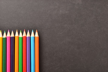 Notebook, colored pencils blackboardの写真素材