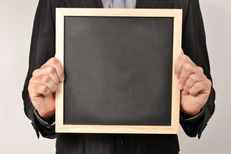 Businessman with blackboardの写真素材