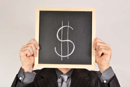 Businessman with dollar blackboardの写真素材