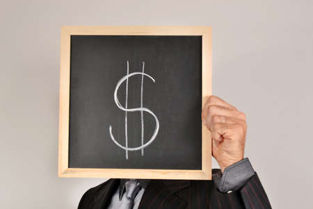 Businessman with dollar blackboardの写真素材