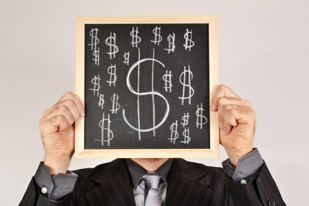 Businessman with dollar blackboardの写真素材