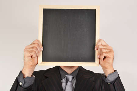 Businessman with blackboardの写真素材