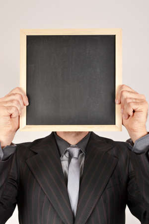 Businessman with blackboardの写真素材
