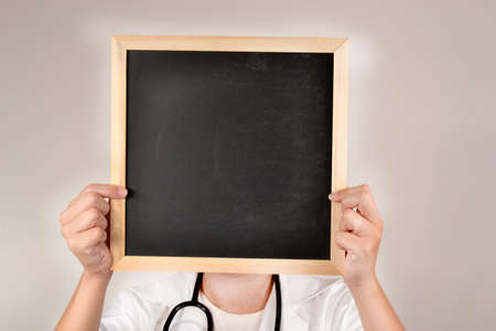 Doctor with smiling face in blackboardの写真素材