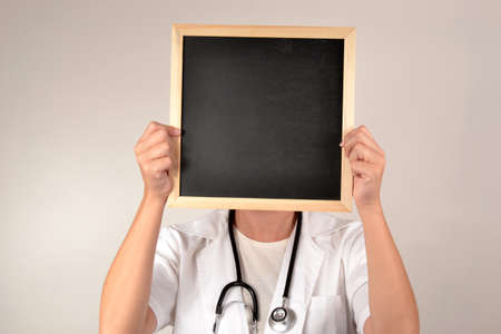 Doctor with smiling face in blackboardの写真素材