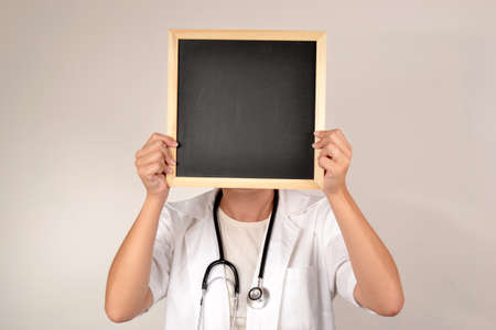 Doctor with smiling face in blackboardの写真素材