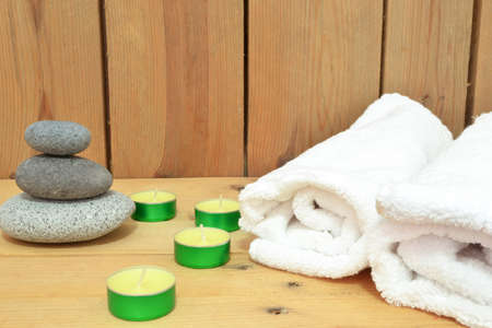 Candles, zen stones and towel on woodの写真素材
