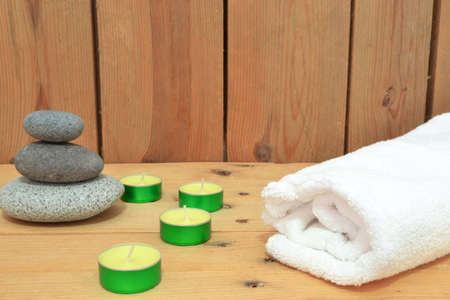 Candles, zen stones and towel on woodの写真素材