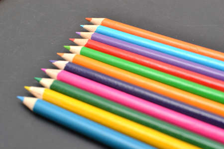 Notebook, colored pencils blackboardの写真素材