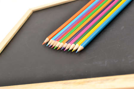 Notebook, colored pencils blackboardの写真素材