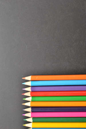 Notebook, colored pencils blackboardの写真素材