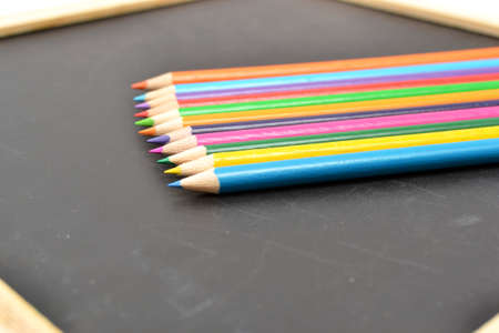 Notebook, colored pencils blackboardの写真素材