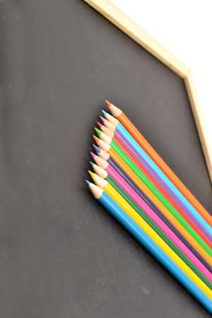 Notebook, colored pencils blackboardの写真素材