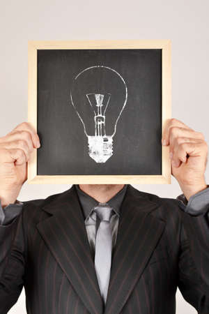 Businessman and bulb in blackboardの写真素材