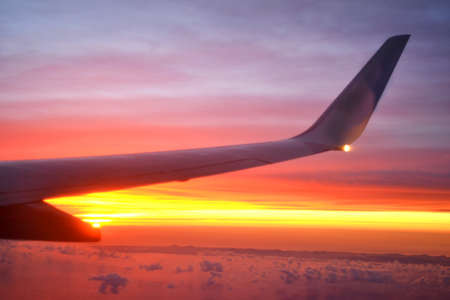 Airplane flying at dawn