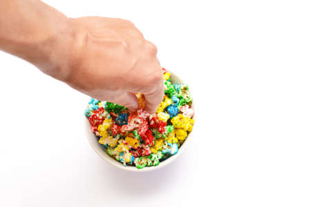 Person picking colors popcorn bowlの写真素材