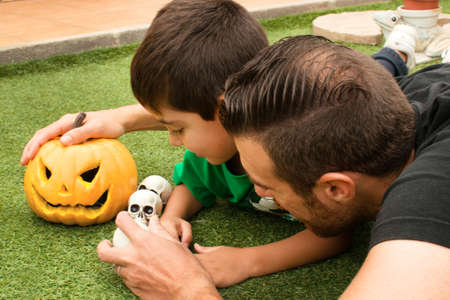 Father with his son playing with Halloween decorationsの写真素材