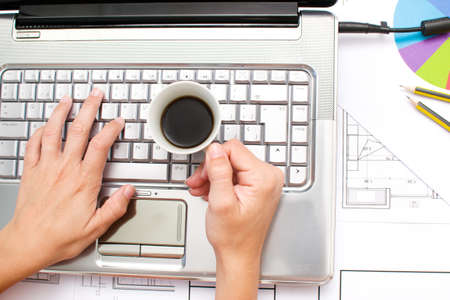 Computer and coffee in the office tableの写真素材