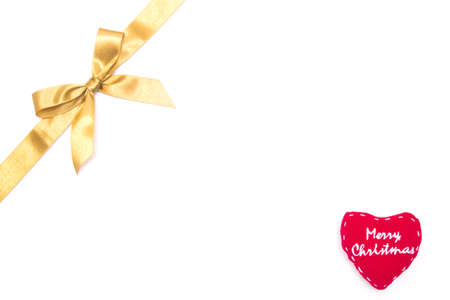 Christmas gold ribbon and heart on white backgroundの写真素材