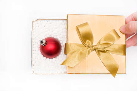 Gift box with a christmas ball insideの写真素材