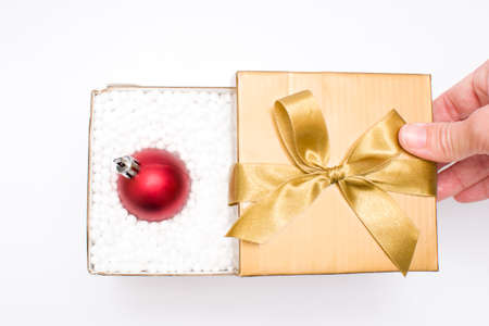 Gift box with a christmas ball insideの写真素材