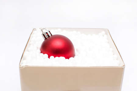 Gift box with a christmas ball insideの写真素材