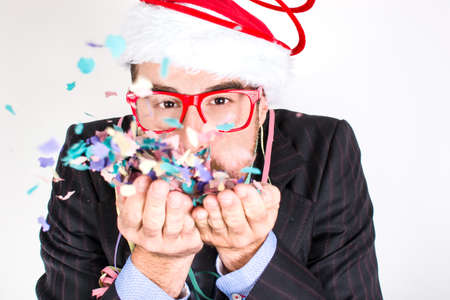 Young man blowing confettiの写真素材