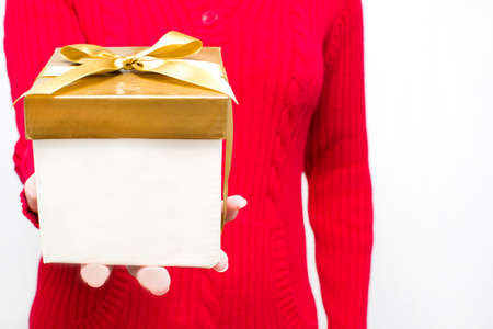 Woman with a gift box in handsの写真素材