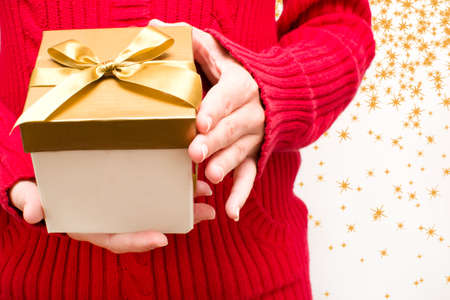 Woman with a gift box in handsの写真素材