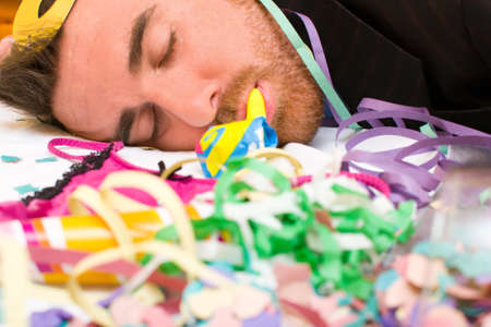 Young man sleeping after a partyの写真素材