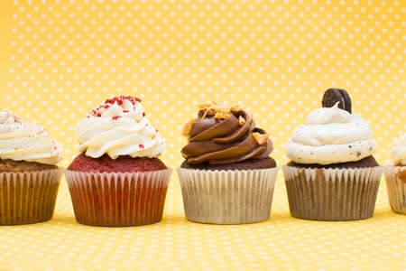 Some cupcakes on yellow backgroundの写真素材