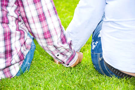Young man and young woman smiling in parkの写真素材