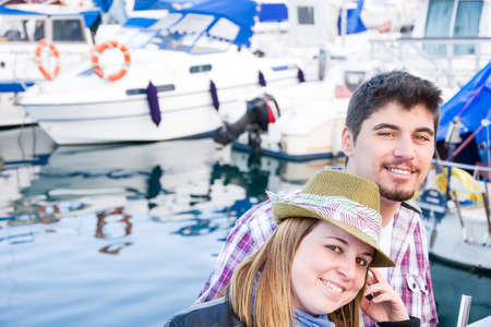 Young woman and young man on a marinaの写真素材