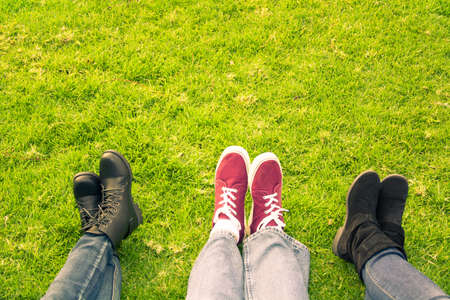 Three legs in shoes on grassの写真素材