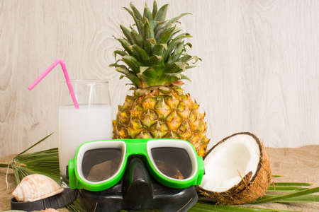 tropical fruit and snorkel on beachの写真素材