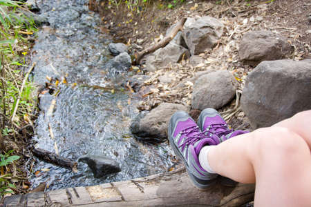 Woman hiking on top of a stream