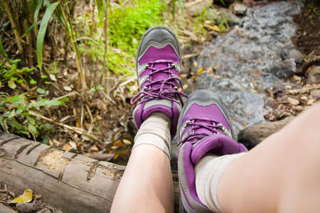 Woman hiking on top of a stream