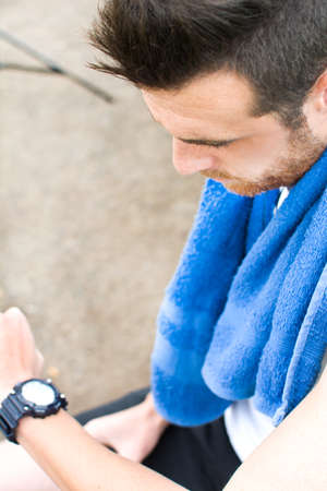Man doing running and watching the watch in park