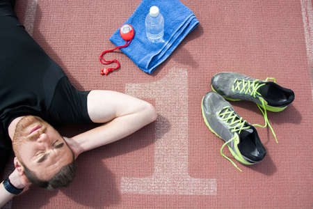Man lying on the running track