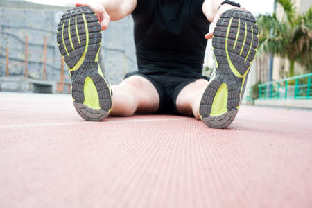 Man doing stretching in the track