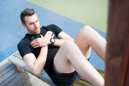 man doing sit-ups in the parkの写真素材