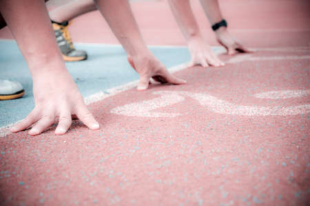 runners at the start of the track